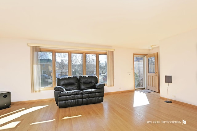 living room featuring wood finished floors and baseboards