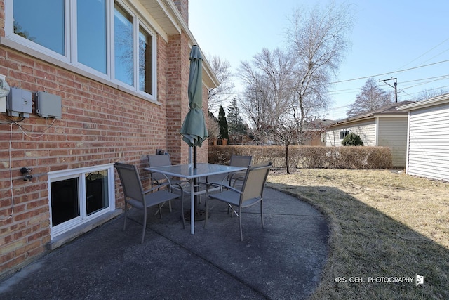 view of patio featuring outdoor dining space and fence