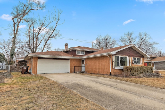 view of front facade with a garage, brick siding, concrete driveway, fence, and a front yard