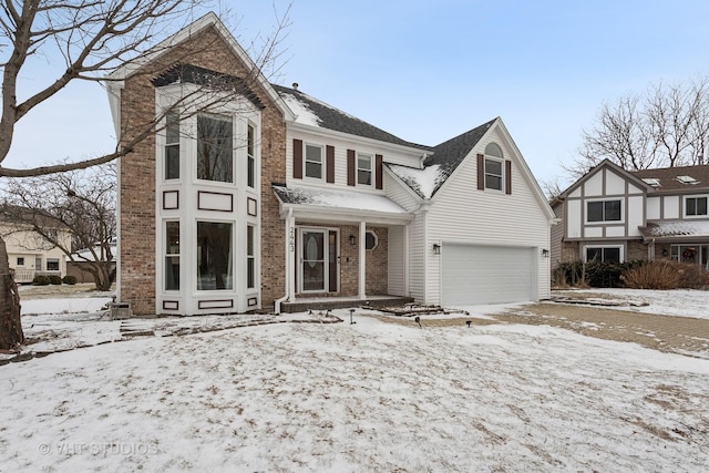 view of front of home featuring a garage and brick siding