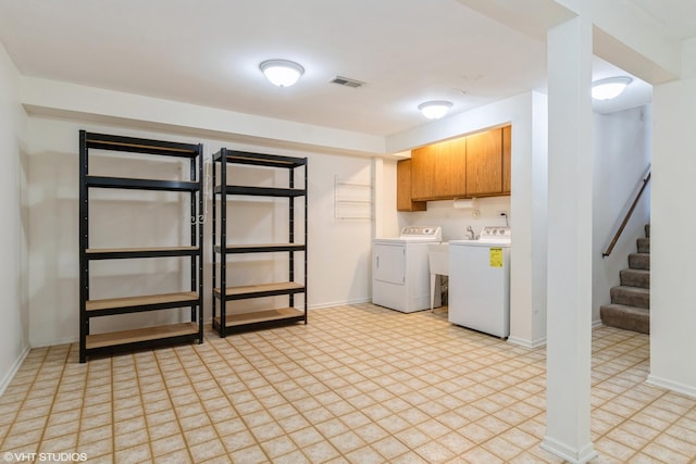 interior space featuring cabinet space, independent washer and dryer, visible vents, and baseboards