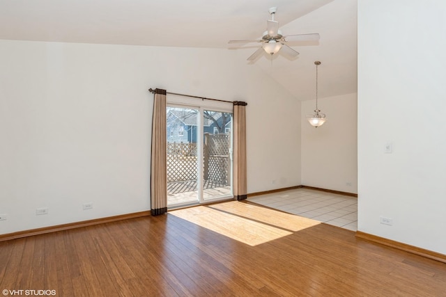 spare room featuring high vaulted ceiling, light wood finished floors, a ceiling fan, and baseboards