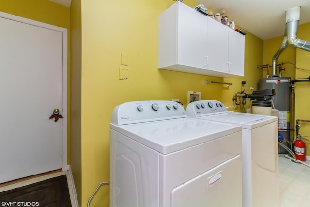 laundry room featuring gas water heater, washing machine and clothes dryer, and cabinet space