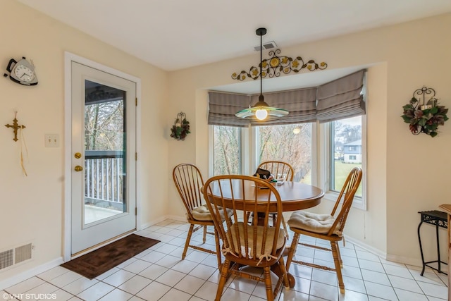 dining area with visible vents, baseboards, and light tile patterned floors