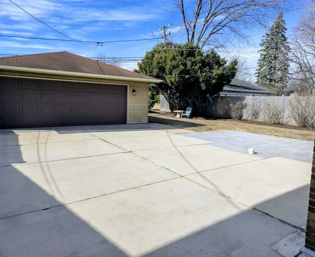 detached garage featuring fence