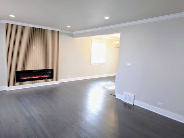 unfurnished living room with dark wood finished floors, recessed lighting, visible vents, ornamental molding, and baseboards