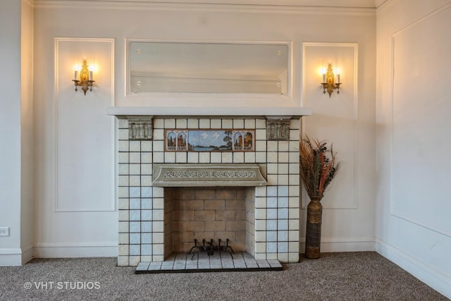 details featuring carpet flooring, a tiled fireplace, and baseboards