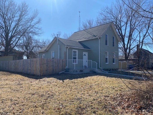 view of front of house with a front yard and fence