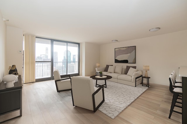 living room with light wood-style floors and expansive windows