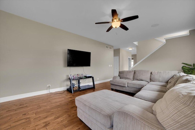 living room with a ceiling fan, baseboards, visible vents, and wood finished floors