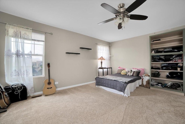 bedroom with carpet floors, visible vents, baseboards, and a ceiling fan