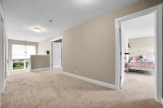 carpeted spare room featuring baseboards