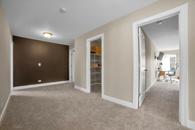 interior space featuring carpet flooring and baseboards