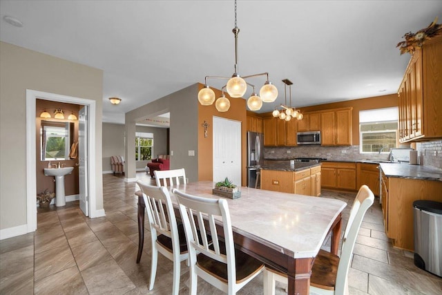 dining space featuring a healthy amount of sunlight and baseboards