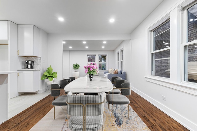 dining area with dark wood-type flooring, recessed lighting, and baseboards