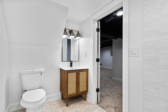 bathroom with vanity, toilet, and baseboards