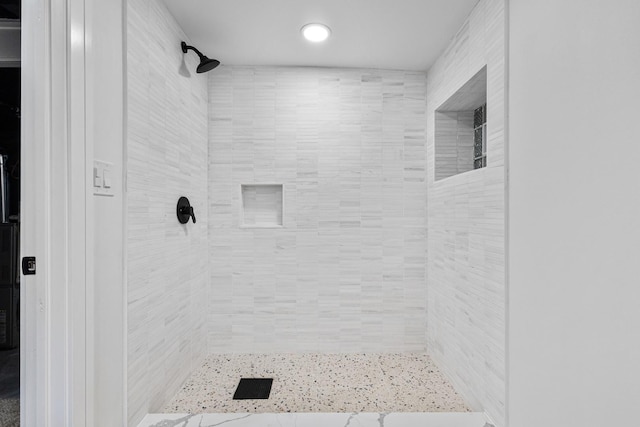 bathroom with tiled shower