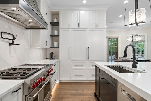 kitchen featuring range with two ovens, custom exhaust hood, crown molding, open shelves, and a sink