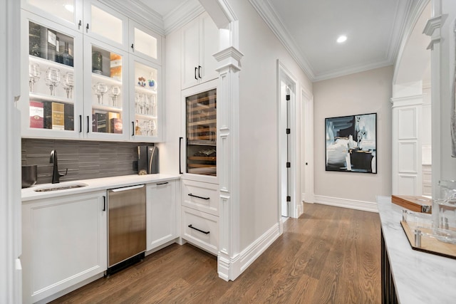 interior space with wine cooler, ornamental molding, dark wood-type flooring, a sink, and dishwasher