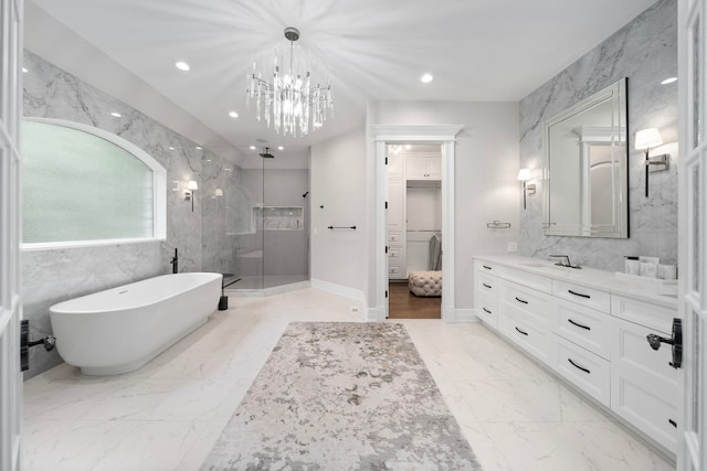 full bath with recessed lighting, vanity, marble finish floor, a soaking tub, and a shower stall