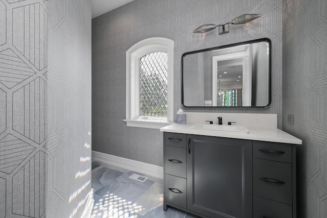 bathroom featuring visible vents, marble finish floor, vanity, and baseboards