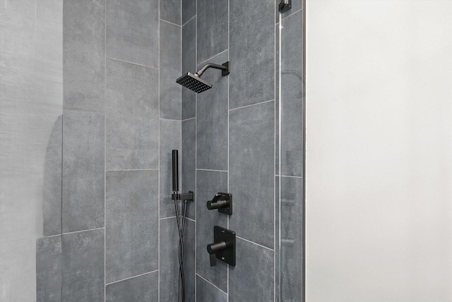 interior details featuring tiled shower