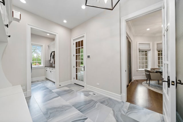 foyer entrance with recessed lighting, marble finish floor, and baseboards