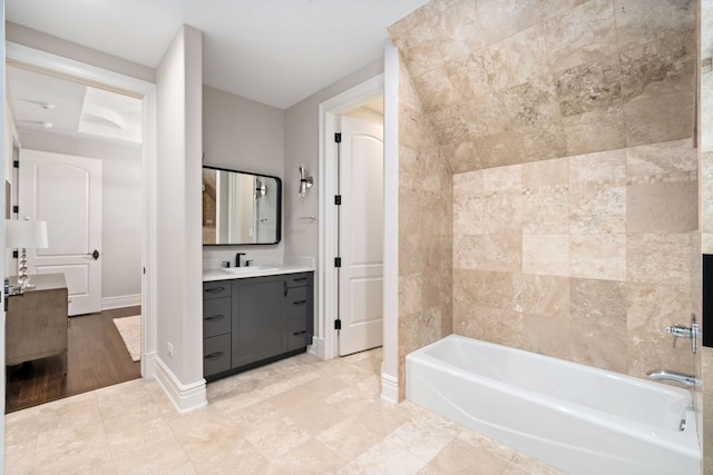 bathroom featuring bathtub / shower combination, baseboards, and vanity