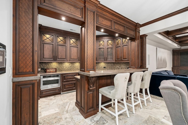 bar with marble finish floor, tasteful backsplash, oven, and crown molding