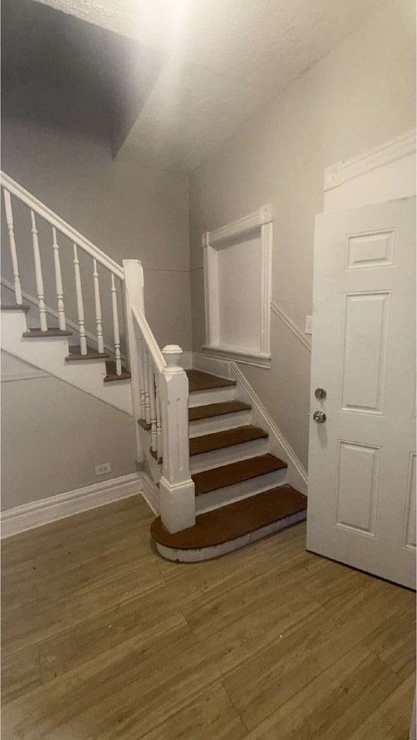 stairs featuring baseboards and wood finished floors