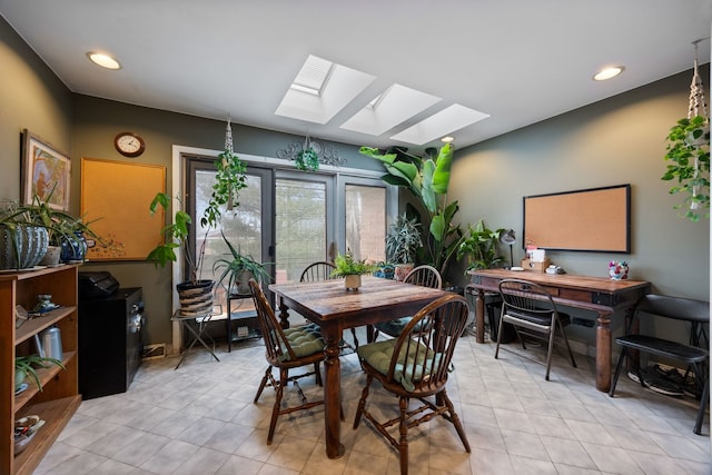 dining space featuring a skylight, light tile patterned floors, and recessed lighting