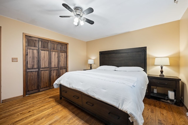 bedroom with a ceiling fan, baseboards, and light wood finished floors