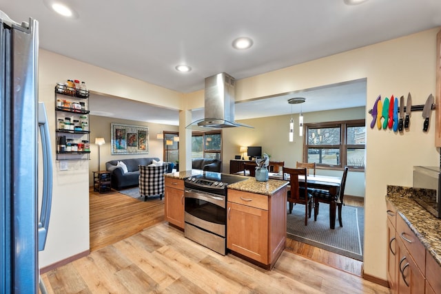 kitchen with stone countertops, stainless steel appliances, open floor plan, light wood-type flooring, and island exhaust hood