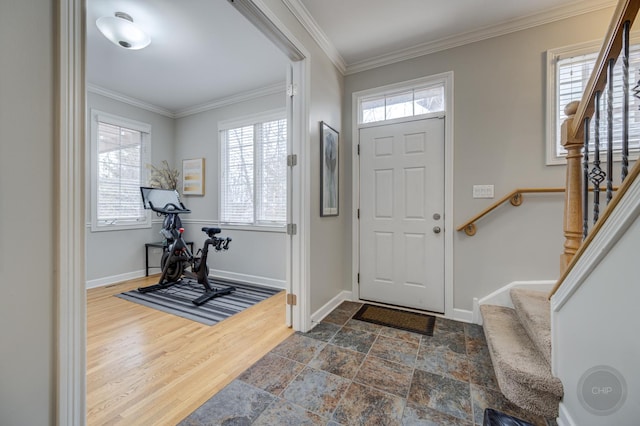 foyer entrance with stairway, a wealth of natural light, and ornamental molding