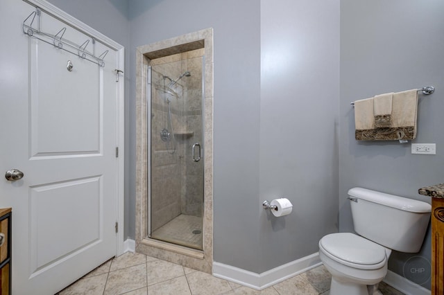 full bathroom featuring toilet, a stall shower, vanity, baseboards, and tile patterned floors