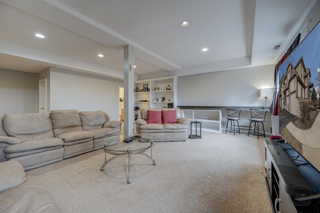 living room featuring carpet floors, recessed lighting, built in features, and a dry bar