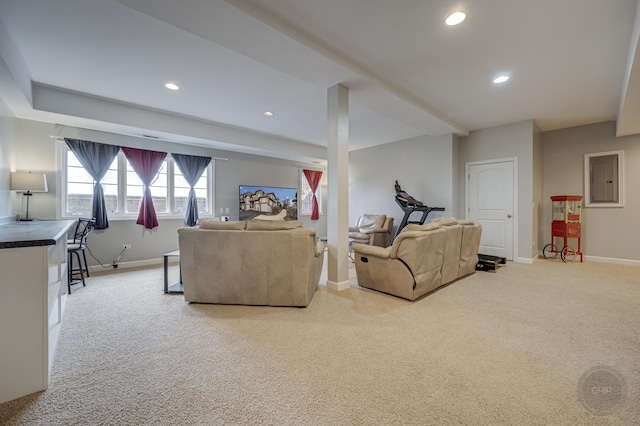 carpeted living room featuring baseboards and recessed lighting