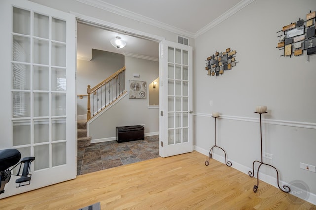 interior space featuring visible vents, ornamental molding, wood finished floors, stairs, and french doors