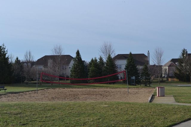 view of home's community featuring volleyball court and a yard