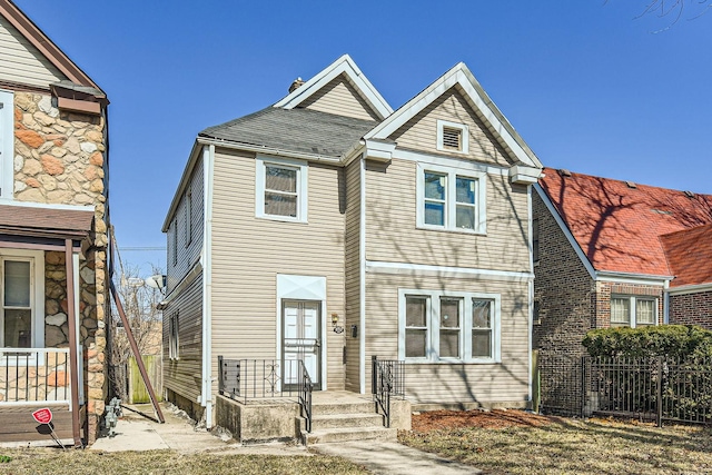 view of front of home featuring fence