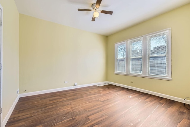 empty room featuring dark wood-style floors and baseboards