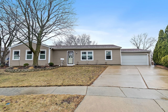 single story home with a garage, a front yard, and concrete driveway