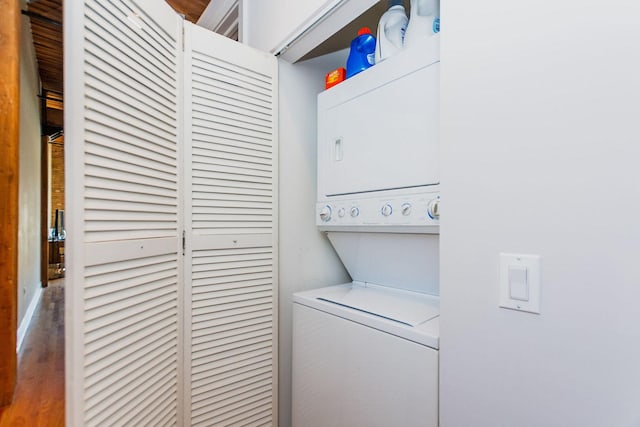 laundry room with stacked washer / dryer and laundry area