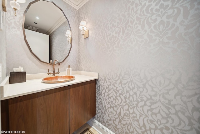 bathroom with vanity and wallpapered walls