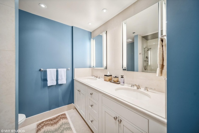 full bath featuring toilet, a shower, a sink, and tile patterned floors