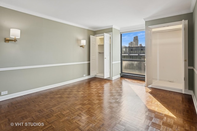 unfurnished room featuring a view of city, crown molding, baseboards, and a baseboard radiator