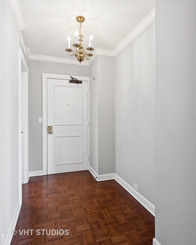 doorway to outside with baseboards, an inviting chandelier, and ornamental molding