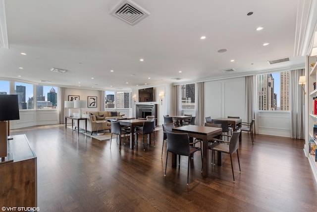 dining room featuring visible vents, a view of city, and a fireplace