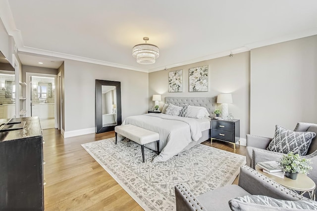 bedroom featuring an inviting chandelier, baseboards, light wood-style floors, and ornamental molding