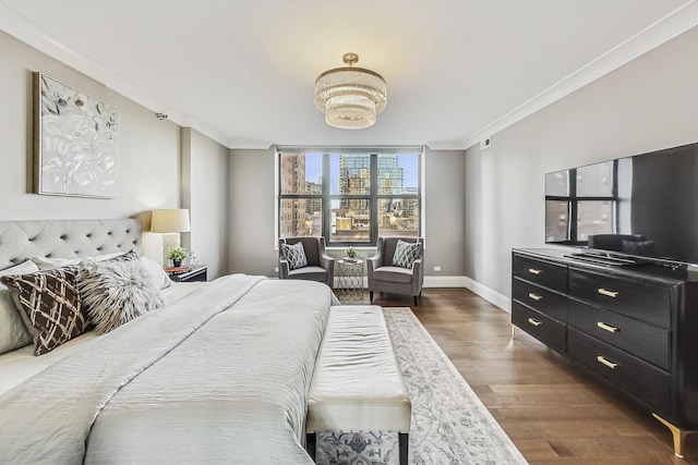 bedroom with dark wood-style flooring, baseboards, and ornamental molding